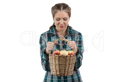 Image of woman looking at basket with apples