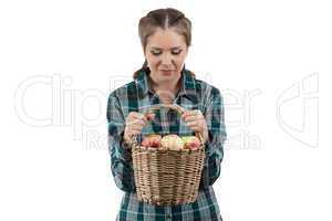 Image of woman looking at basket with apples