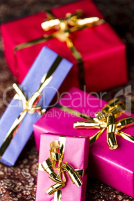 Four Wrapped Gifts with Golden Bows.