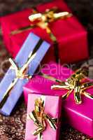 Four Wrapped Gifts with Golden Bows.