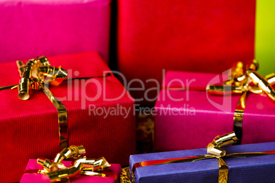 Four Golden Bows around Wrapped Presents