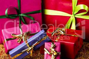 Six Bows Tied around Unicolored Gift Boxes.
