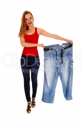 Woman holding big pants.