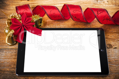 tablet pc with christmas decorations on wooden background