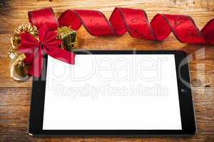 tablet pc with christmas decorations on wooden background