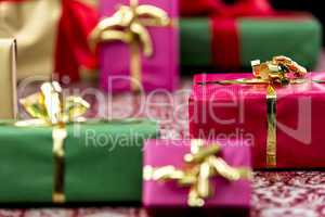 Wrapped Presents with Bows in Gold and Red