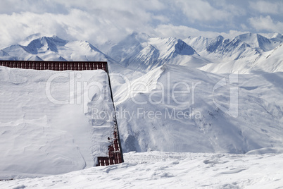 Hotel in snow and ski slope
