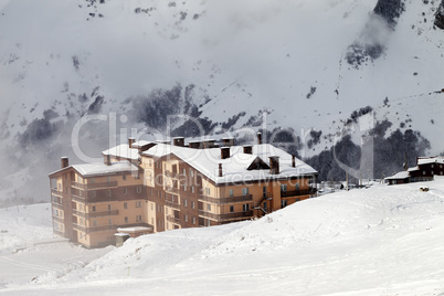 Hotel and ski slope at fog day