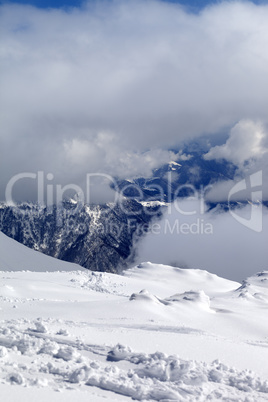 View on winter snowy mountains in clouds