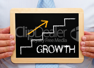 Growth - Businessman with Chalkboard