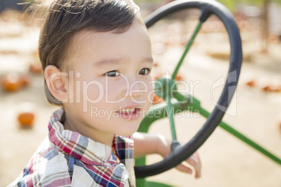 Mixed Race Young Boy Playing on Tractor