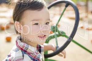 Mixed Race Young Boy Playing on Tractor