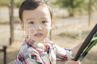 Mixed Race Young Boy Playing on Tractor