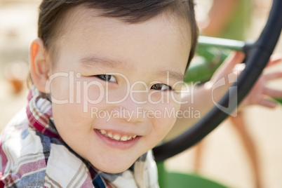 Mixed Race Young Boy Playing on Tractor