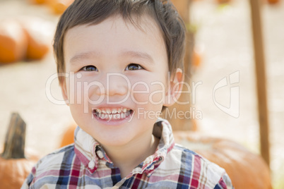 Mixed Race Young Boy Having Fun at the Pumpkin Patch