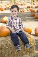 Mixed Race Young Boy Having Fun at the Pumpkin Patch