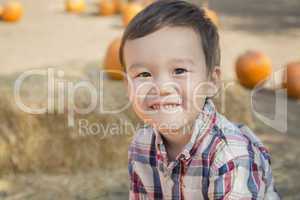 Mixed Race Young Boy Having Fun at the Pumpkin Patch