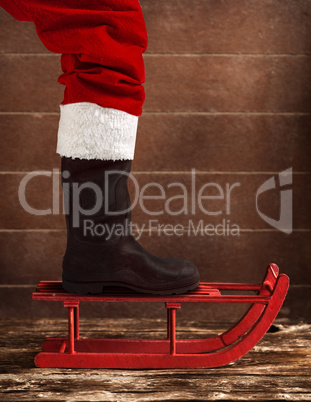 Red sled with the boot of Santa Claus