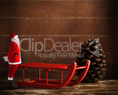 Red sled with pine cone and Santa Claus