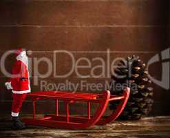 Red sled with pine cone and Santa Claus