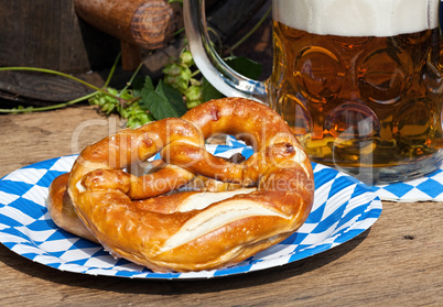 Beer and pretzel on a paper plate