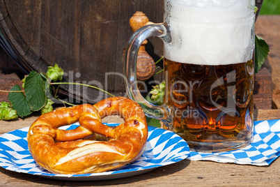 Beer and pretzel on a paper plate