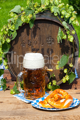 Barrel with hops and a large glass of beer
