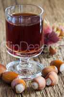 Hazelnut liqueur in a glass and hazelnuts