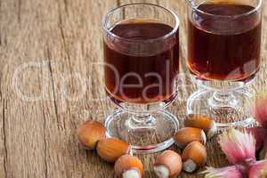 Hazelnut liqueur in two glasses and hazelnuts