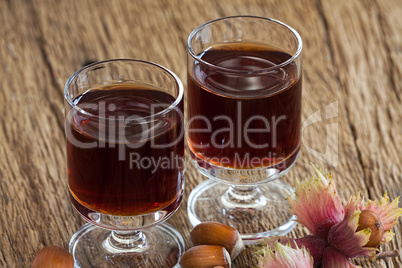 Hazelnut liqueur in two glasses and hazelnuts