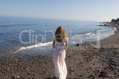 young woman standing on beach