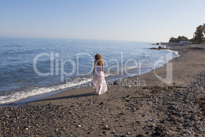 young woman walking on the beach
