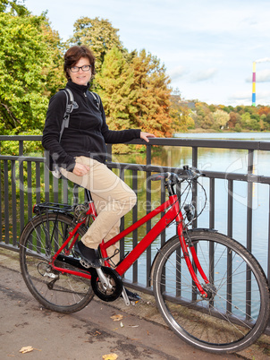 Woman riding a bicycle in autumn park