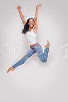 Young woman having fun jumping in studio