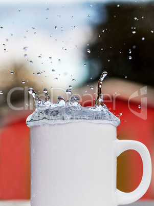 Cup of water running over