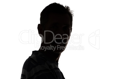 Silhouette of a man looking at camera