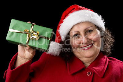 Elderly Woman Holding up a Green Wrapped Xmas Gift.