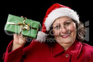 Elderly Woman Holding up a Green Wrapped Xmas Gift.