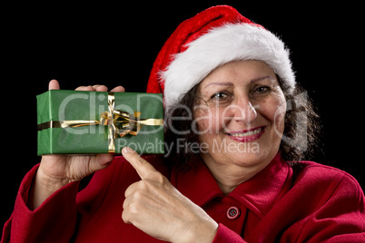 Female Senior Pointing at Green Wrapped Present.