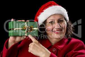 Female Senior Pointing at Green Wrapped Present.