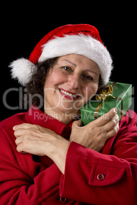 Happy Aged Woman with Santa Cap and Wrapped Gift.