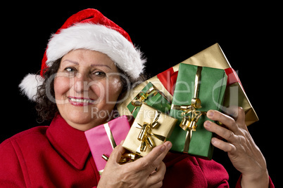 Mature Lady Holding Up Five Christmas Presents.