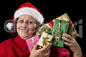 Mature Lady Holding Up Five Christmas Presents.