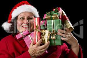 Happy Female Senior Lifting Many Wrapped Presents.