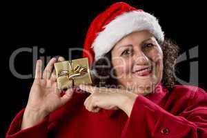 Happy Old Woman with Red Cap Points at Xmas Gift.