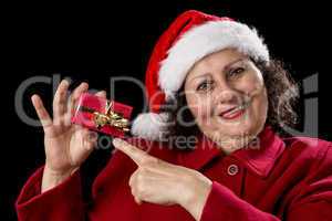 Joyful Aged Lady Pointing at Red Christmas Gift.