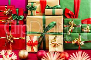Three Piles of Xmas Gifts in Red, Gold and Green