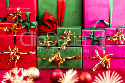 Three Stacks of Xmas Presents Arranged by Color
