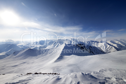 Off-piste slope and sky with sun