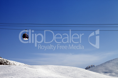 Gondola lift and ski slope at sun day